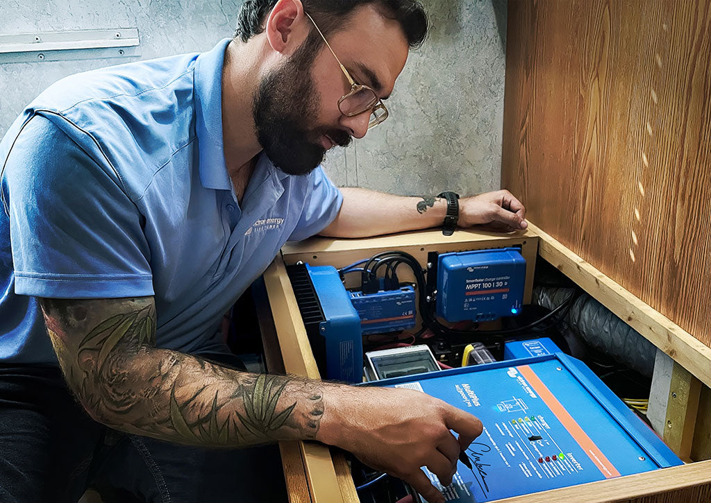 A technician working on a Victron Energy installation