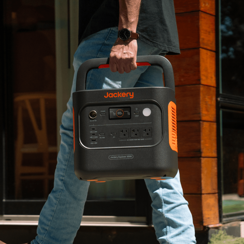 Carrying a Jackery power station outside a cabin